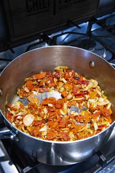 a pan filled with food sitting on top of a stove