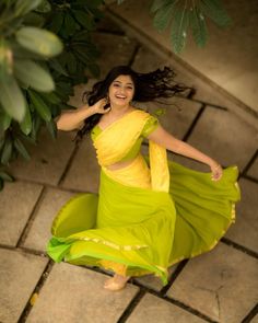 a woman in a yellow dress is dancing