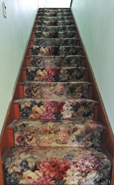 a set of stairs with floral fabric on the bottom, and hand painted flowers on each step