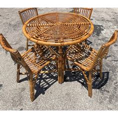 a table and chairs made out of wicker sitting on the ground in a parking lot