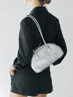 Editor's NoteJoseph & Stacy pursues design and craftsmanship with artistic sensibility that transcends time  trend  and age. - Half moon shaped bag- Small pocket on the back- Studs on the bottom- Snap button on the handleMeasurements (in.)- Size: 11.42 in. (W) * 6.61 in. (H) * 3.15 in.- Strap: 27.17 in. (Handle Drop: 12.01 in.) Composition & Care- 100% Cowhide (Crinkled Leather)- Due to the nature of leather products made using natural leather  fine scratches  differences in le Modern Silver Evening Bag For Daily Use, Modern Silver Bag With Round Handle, Modern Silver Shoulder Bag With Round Handle, Dark Outfits, Bowling Bags, Moon Shapes, Leather Products, Leather Texture, Leather Cleaning