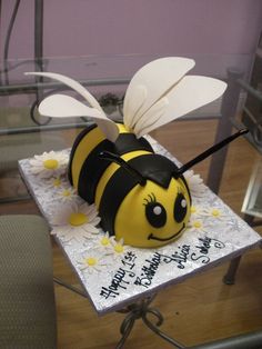 a cake shaped like a bee sitting on top of a table