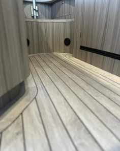 the inside of a boat with wood flooring