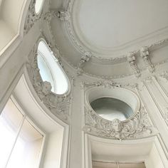 an ornate ceiling with three round windows