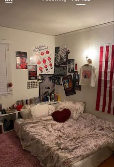 a bedroom with an american flag on the wall and pictures above the bed in it