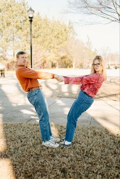 a man and woman are dancing in the grass