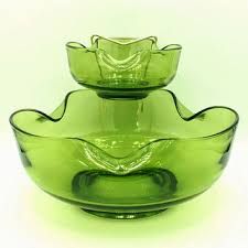 three green glass bowls sitting on top of each other