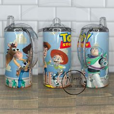 three toy story mugs sitting on top of a wooden table