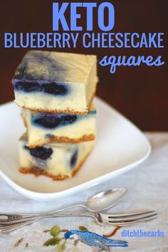 three blueberry cheesecake squares on a plate with silverware next to it and the title overlay reads keto blueberry cheesecake squares squares