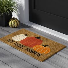 a door mat that says, let there pumpkins on it