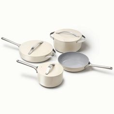 three pots and two pans on a white surface