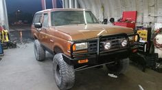 a brown truck parked inside of a garage