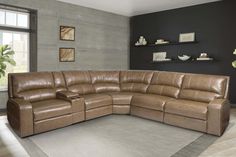 a large brown leather sectional sofa in a living room