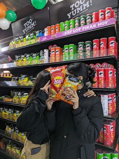 two women standing in front of a store shelf