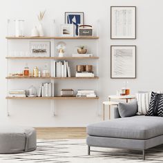 a living room filled with lots of furniture next to a wall mounted bookshelf