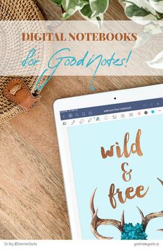 a tablet with the words wild and free on it next to a hat, plant and other items