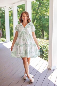 Ivory tiered dress with traditional sea green Willow print Bring a touch of whimsy to your wardrobe with our Green Willow Print Dress. The beautiful sea green willow print and sea green trim will make you stand out while the babydoll silhouette will keep you comfy. This sweet dress will make you feel effortlessly stylish no matter the occasion! True to size fit Model is 5'3" wearing a small Fabric does not contain stretch Removable belt V cut neckline Functioning front buttons Short puff sleeves Green Cotton Dress With Ruffle Hem, Green Tiered Dresses For Daywear, Green Tiered Cotton Dress, Classic Style Dresses, Dressy Summer Dresses, Printed Short Dresses, Vintage Couture, Beautiful Sea, Dresses Vintage