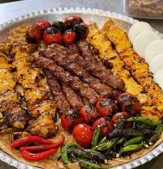 a platter filled with meat and vegetables on top of a table