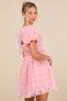 Flirt your way through all the cutest events in the Lulus Utterly Adored Pink Tulle Textured Puff Sleeve Bow Mini Dress! Dreamy tulle boasts a cloud-like textured effect (with contrasting white stitching) as it shapes short puff sleeves with elastic at the cuffs. Square neckline tops a princess-seamed bodice with a single tie at the back and a fitted waist. Skirt has a flaring silhouette that ends at a ruffled mini hem. Darling bow details throughout lend a coquette finish. Hidden zipper/clasp at back. Fit: This garment fits true to size. Length: Mid-thigh. Size medium measures 33" from shoulder to hem. Bust: Great for any cup size. Waist: Fitted - very fitted at natural waist. Hip: Not Fitted - fuller skirt allows room for hips. Undergarments: May be worn with a strapless bra, adhesive br Tulle Texture, Bow Mini Dress, Puff Sleeve Mini Dress, Pink Tulle, Strapless Bra, Mini Dress With Sleeves, Full Skirt, Square Neckline, Puff Sleeves