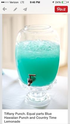 a glass filled with blue liquid sitting on top of a table