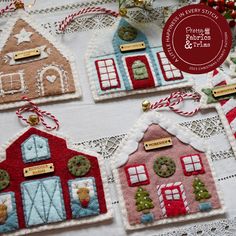 christmas ornaments are displayed on a table with lace and twine trimming around them