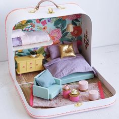 a dollhouse bedroom with furniture and accessories in the inside of an open suitcase case