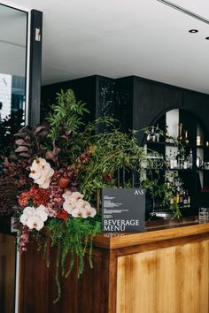 flowers and greenery are on display at the bar