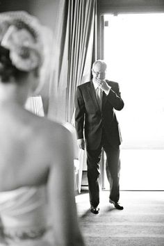 a man standing next to a woman in front of a window