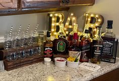 the bar is filled with liquor bottles, glasses, and other items for making cocktails