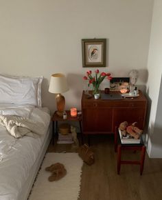 a bed room with a neatly made bed and a night stand