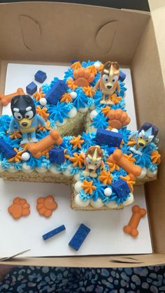 a decorated cake in the shape of a number six with angry birds on it and blue frosting