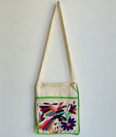 OOAK tote bag handmade and hand-embroidered in a vibrant colors by artisans from Tenango de Doria Hidalgo Mexico. This beautiful bag is handcrafted needlework embroidered by our artisan partners from Tenango de Doria Hidalgo Mexico- Otomi Art.  Each bag is lovingly crafted and unique. There is no other like it. Notice that the animal and flowers are shaped, designed in the thought of the otomi culture. We unknown the meaning of the animal, however it has an ancestral meaning. Embroidered on the Rectangular Cotton Bags With Multicolor Embroidery, Multicolor Embroidered Cotton Tote Shoulder Bag, Daily Use Cotton Shoulder Bag With Multicolor Embroidery, Daily Use Multicolor Embroidered Cotton Shoulder Bag, Handmade Multicolor Embroidered Shoulder Bag For Market, Green Cotton Bags With Embroidery, Handmade Multicolor Embroidery Shoulder Bag For Market, Artisan Handmade Multicolor Embroidered Shoulder Bag, Multicolor Embroidered Cotton Shoulder Bag For Everyday Use