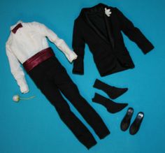 a doll is laying on the ground next to shoes and a suit with a bow tie