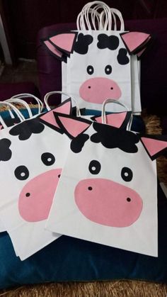 three paper bags with cows painted on them