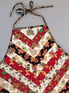 the apron is decorated with gingerbreads and candy canes on it's side