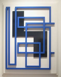 a blue and black abstract painting on a white wall