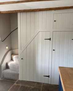 the interior of a house with white painted walls and stairs