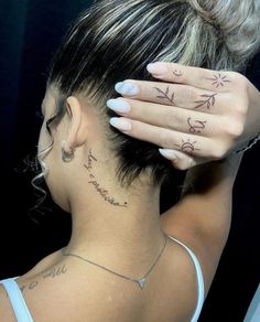 a woman with tattoos on her neck and hand