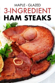 an image of ham steaks on a plate with eggs and parsley garnish