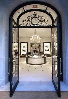 an entrance to a store with chandelier and jewelry