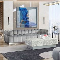 a modern living room with grey couches and art work on the wall behind it