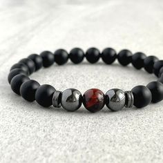 Men's beaded bracelet made with strong, stretchy cord and genuine/natural gemstones. Features ~ 6mm, 8mm or 10mm Matte Onyx beads ~ 6mm, 8mm or 10mm Red Tiger Eye bead ~ 6mm, 8mm or 10mm Hematite round beads ~ 4mm, 6mm or 8mm Hematite spacer beads ~ Stretchy cord; simply slide bracelet on and off wrist ~ Comes packaged in a re-usable microfiber pouch To ensure the perfect fit, please use the bracelet sizing instructions found in the photo gallery. Onyx - A powerful protection stone, Black Onyx a Mens Bracelet Set, Slide Bracelet, Red Tiger, Red Tigers Eye, Tiger Eye Beads, Onyx Bead, Beaded Jewelry Diy, Stone Bracelet