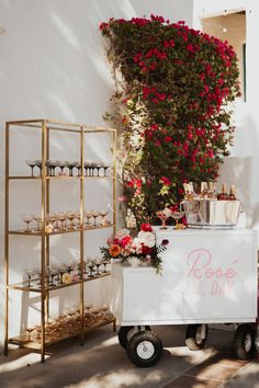 a white cart with flowers and drinks on it