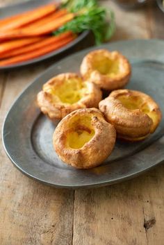 three mini pies on a plate with carrots in the background