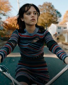 a woman riding on the back of a skateboard