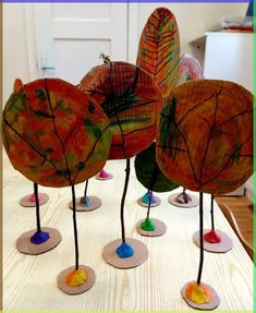 four leaf shaped sculptures sitting on top of a table