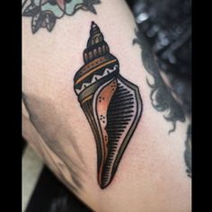 an image of a tattoo on someone's arm that has a sea shell in it