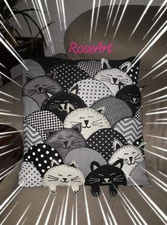 a black and white cat pillow on a chair with the word roseart written in pink