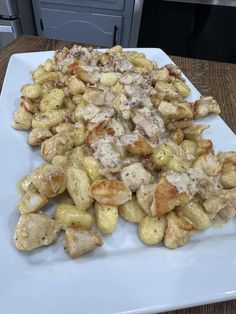 a white plate topped with chicken and potatoes