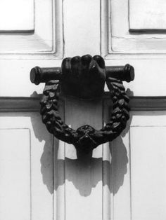 a black and white photo of a door handle